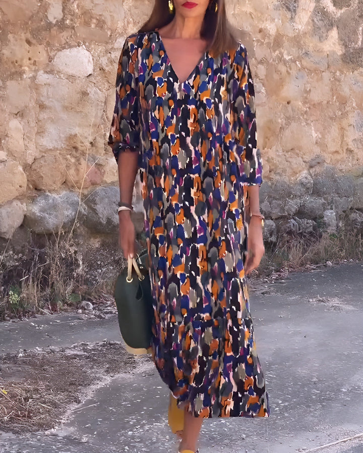 Woman wearing the Hadley flowy printed V-neck dress in multicolor retro print, front view showing flattering silhouette