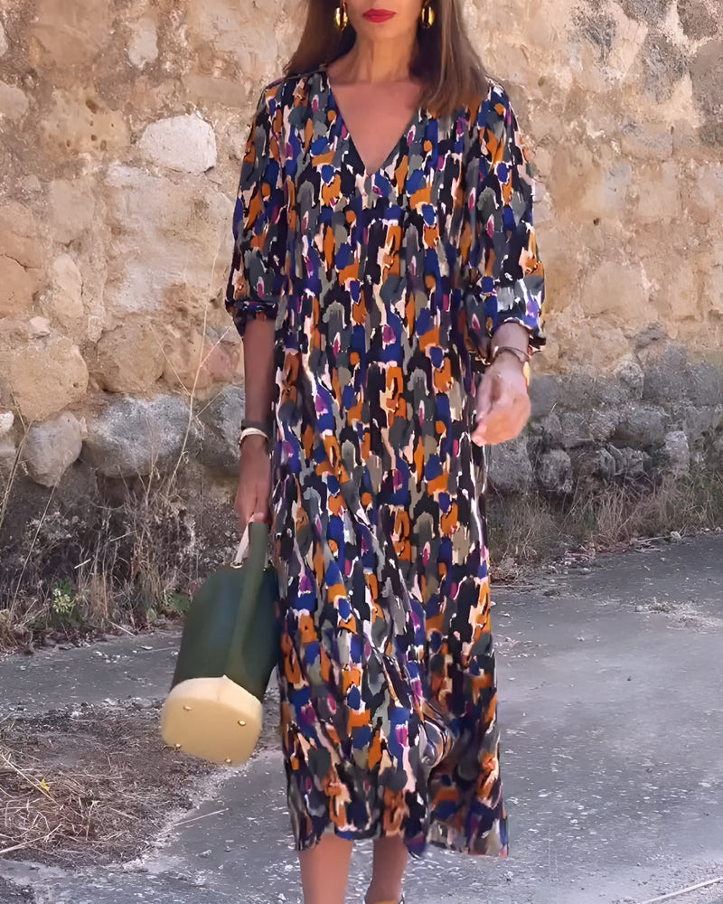 Full-length back view of the Hadley V-neck printed dress in multicolor, showing graceful flowing skirt