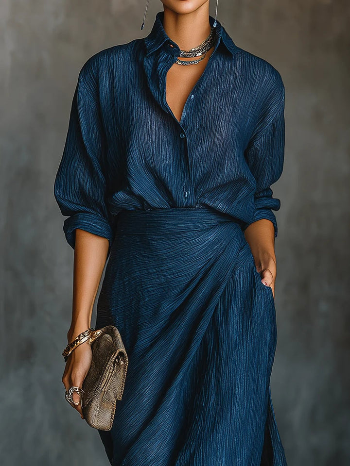 Close-up detail of the dark blue shirt and maxi skirt set, highlighting the rich color and fabric drape