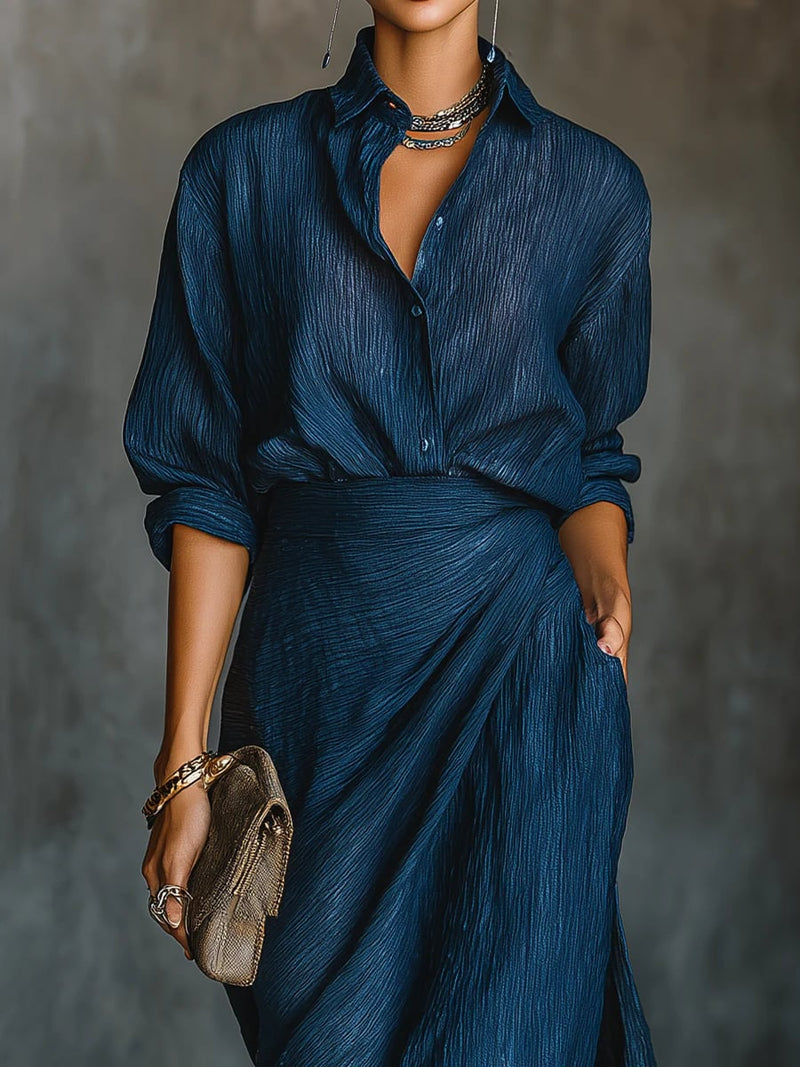 Close-up detail of the dark blue shirt and maxi skirt set, highlighting the rich color and fabric drape