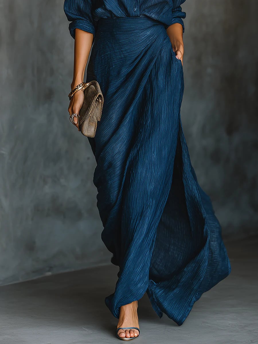 Back view of the elegant dark blue shirt and long skirt two-piece set worn by a woman