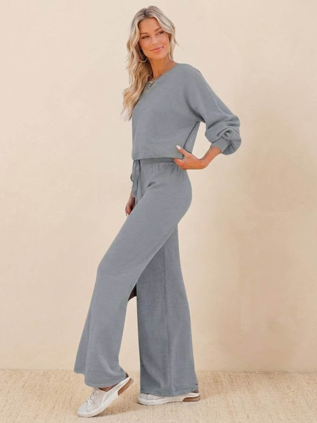 Side view of the Hailey two-piece set in dark green showing wide-leg silhouette