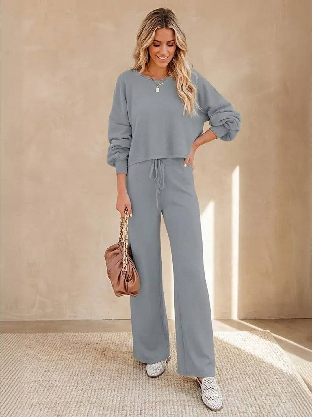 Woman wearing the Hailey lounge set in green with slides