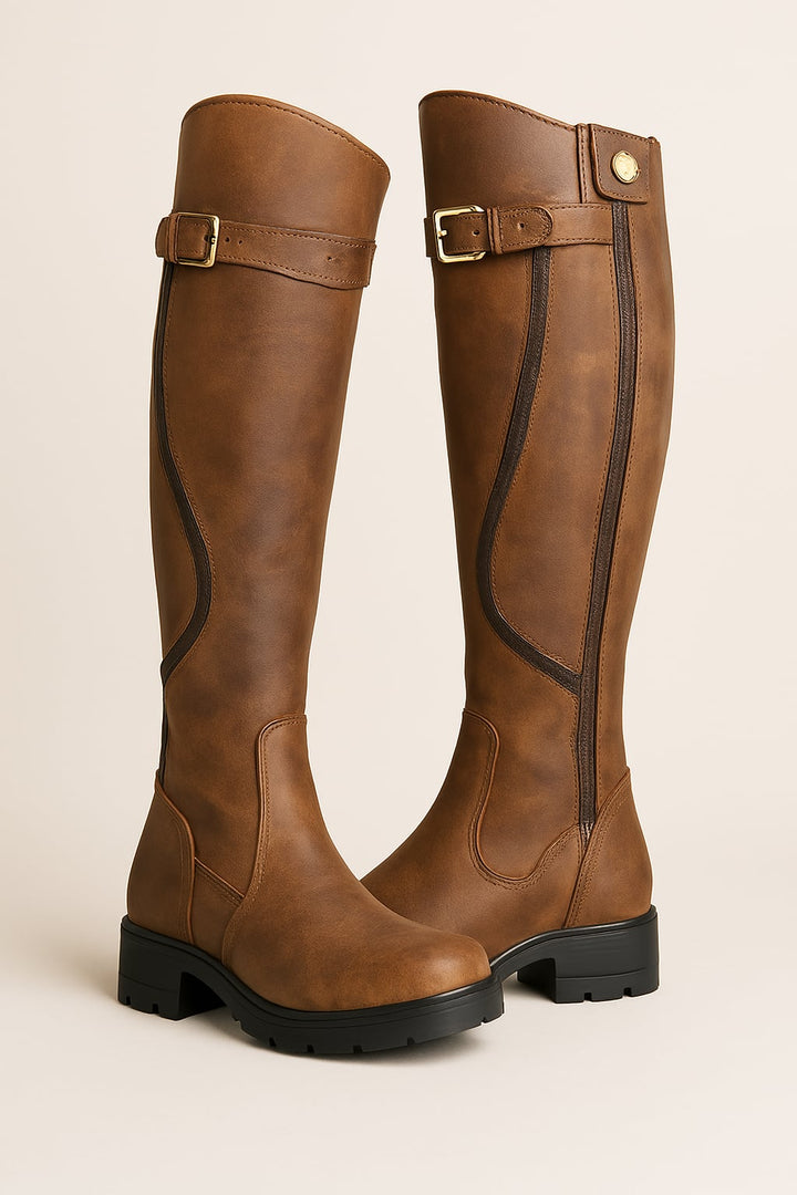 Woman wearing brown tall high boots with a sleek leg-lengthening silhouette, styled for everyday wear