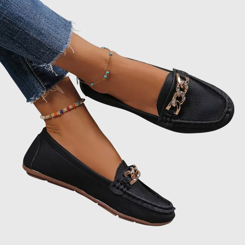 Side view of Harlow white loafers showing moccasin-style topstitching and pebbled faux leather upper