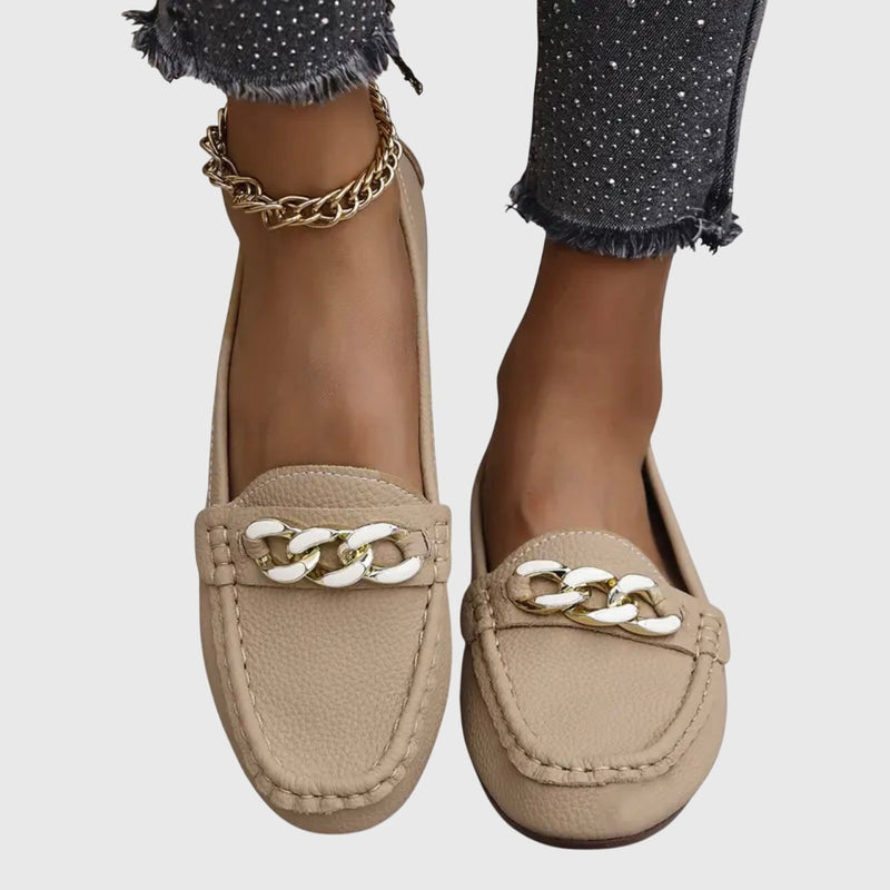 Front view of Harlow white chain loafers highlighting gold-tone chain accent and toe box stitching