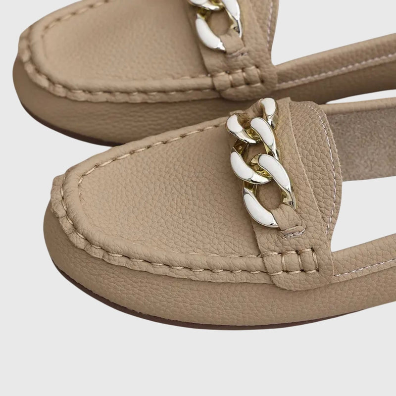 Overhead flat lay of Harlow white loafers on a clean light background