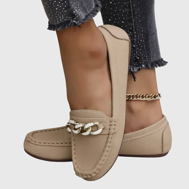 Harlow loafers in beige with gold chain accent, side view on neutral background