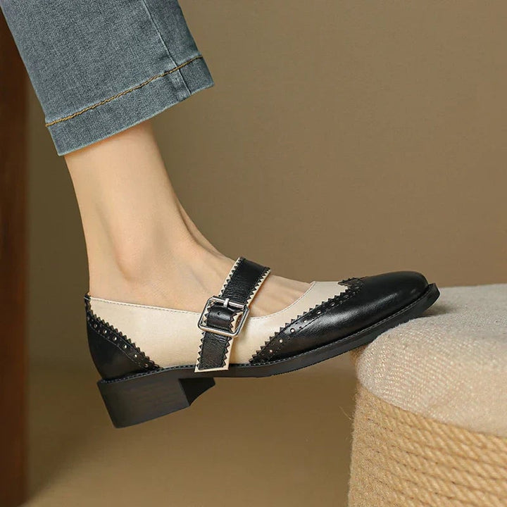 Side profile of Harlow two-tone mary jane shoes showing low block heel and contrast leather panels