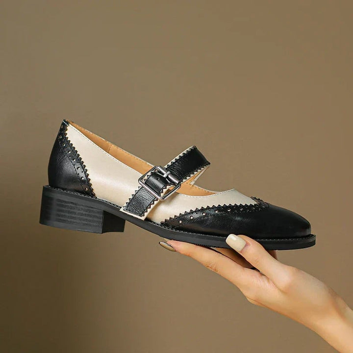 Close-up of brogue scalloped trim and adjustable T-strap buckle on Harlow mary jane shoes