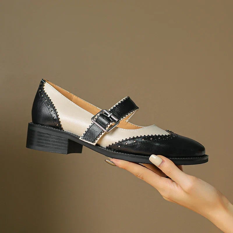 Close-up of brogue scalloped trim and adjustable T-strap buckle on Harlow mary jane shoes