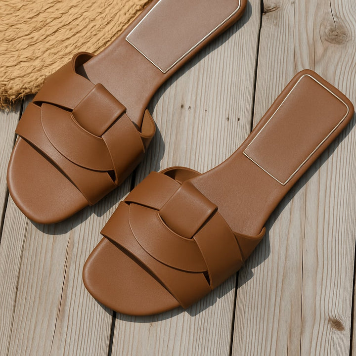 Close-up of Harper slides cushioned footbed and slip-on strap detail
