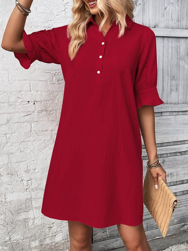 Model wearing the Harper shirt dress in black paired with white sneakers for a casual look