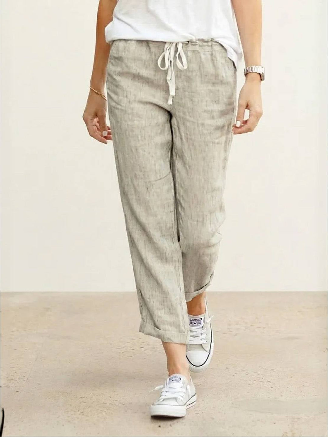 Front view of Harper straight-leg drawstring pants in apricot with roll-up hem detail