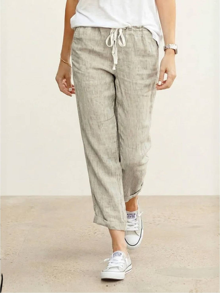 Front view of Harper straight-leg drawstring pants in apricot with roll-up hem detail