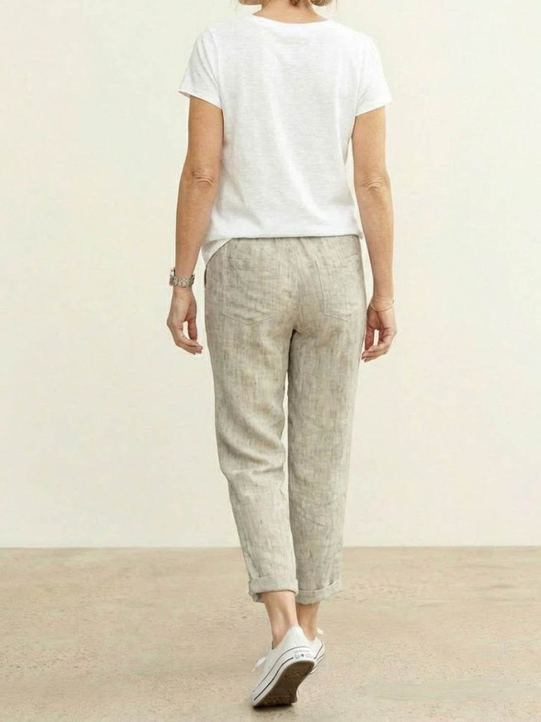 Side view of Harper drawstring pants in apricot highlighting linen-look texture