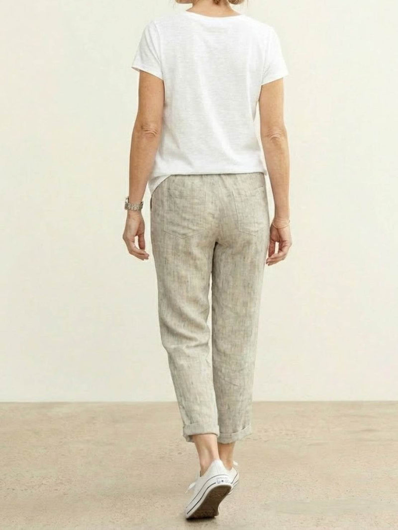 Side view of Harper drawstring pants in apricot highlighting linen-look texture
