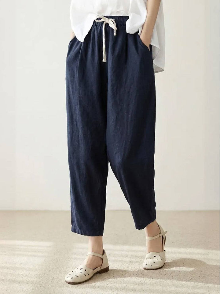Close-up of roll-up hem cuff detail on Harper straight-leg pants in apricot