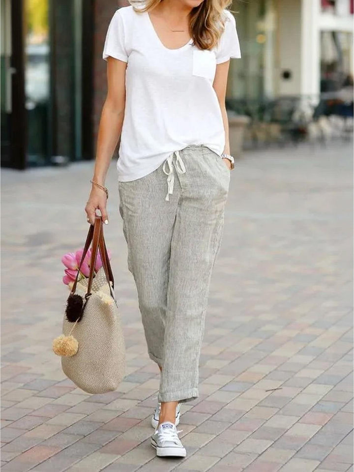 Side view of Harper drawstring pants in black with linen-look fabric detail