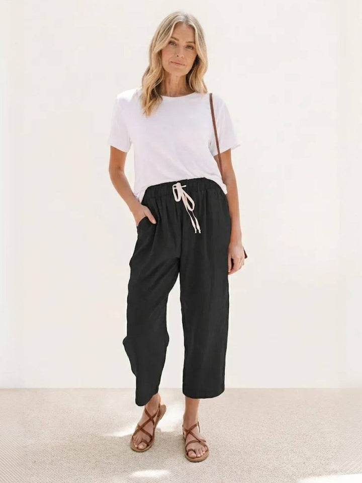Close-up of roll-up hem cuff on Harper pants in rusty orange