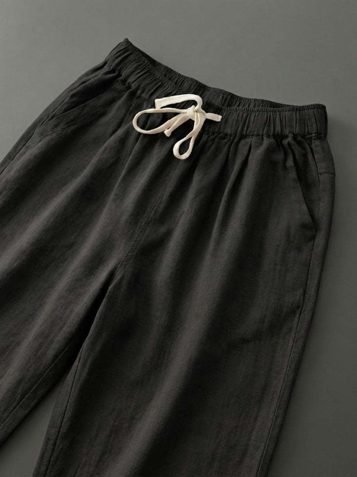Full-length front view of Harper straight-leg pants in navy blue