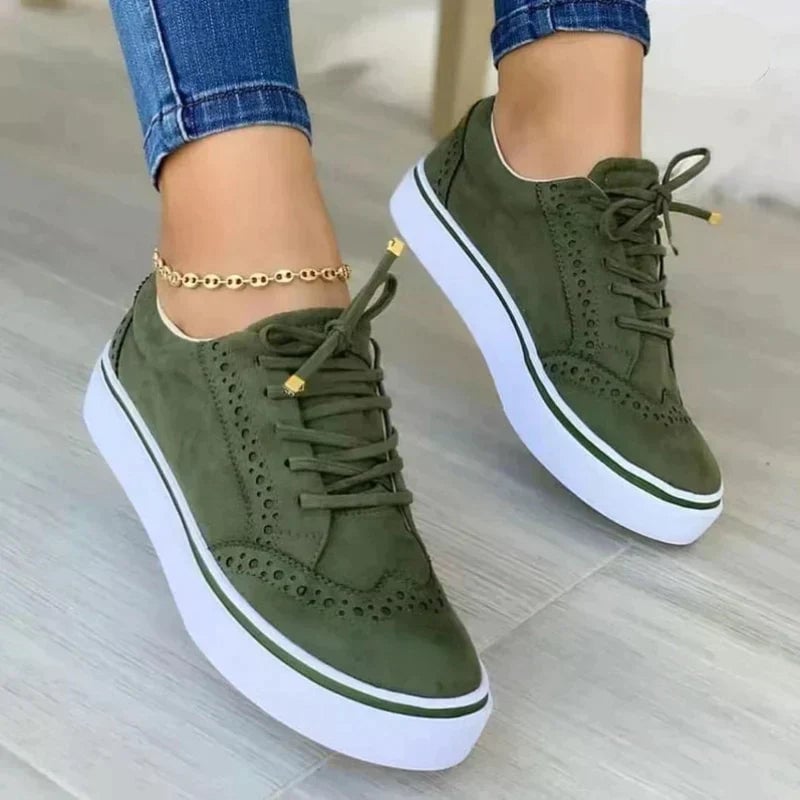 Harper platform sneaker in green with gold-tipped laces and chunky white sole, side profile view