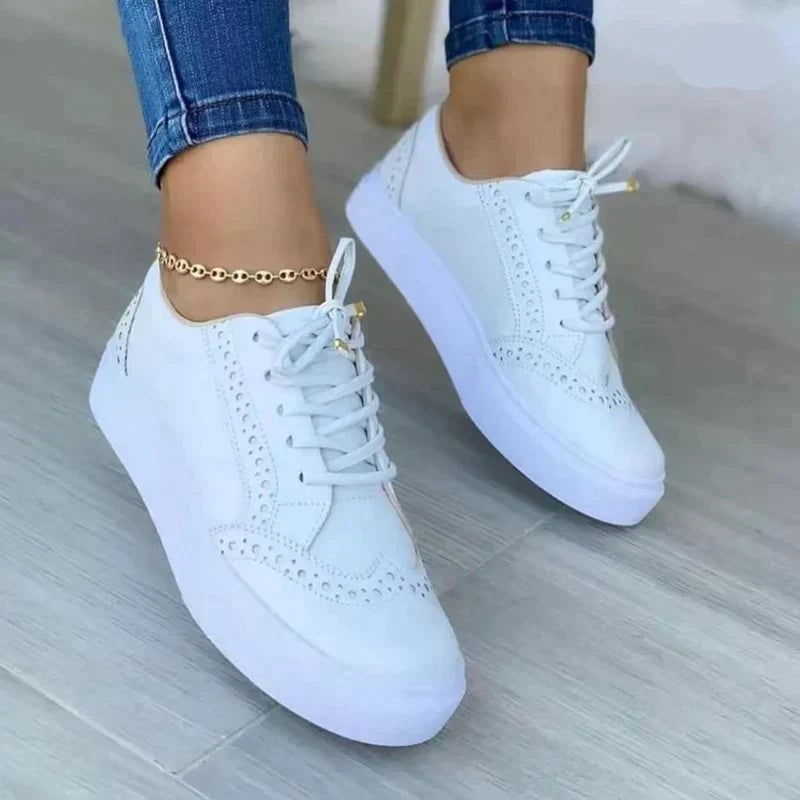 Harper platform sneaker in white with brogue detailing and gold aglets, flat lay overhead view