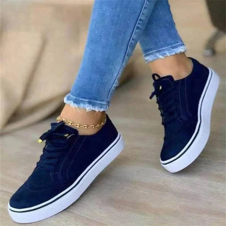 Harper women's platform sneaker in blue, close-up of brogue punch-out detailing along the toe box