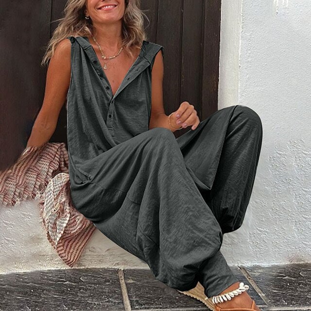 Woman wearing the Harper sleeveless hooded jumpsuit in dark gray with wide-leg fit, front view