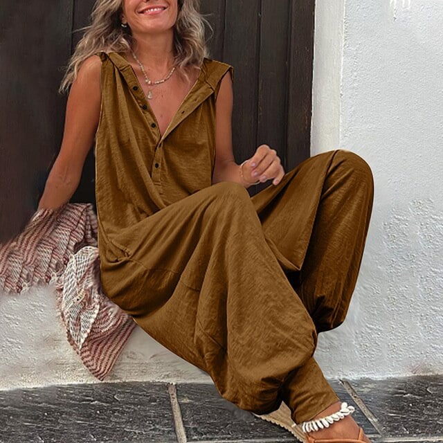 Woman styling the Harper sleeveless jumpsuit in wine red with casual sandals