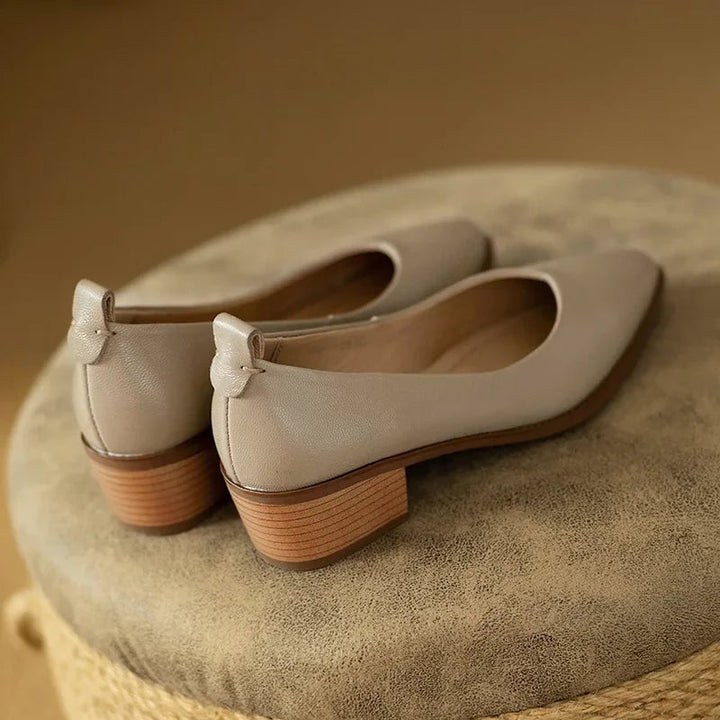 Harriet block heel pump in beige on a flat surface, sole detail visible