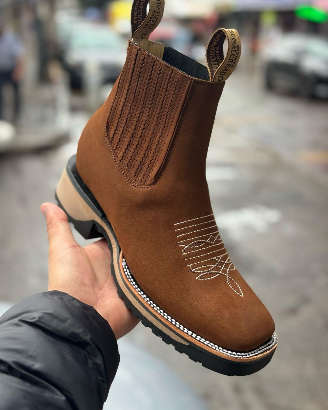Close-up detail of Haven cowboy boots showing stitching and leather texture in light brown