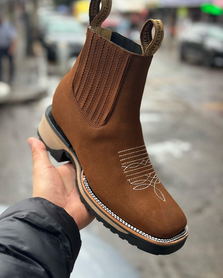 Close-up detail of Haven cowboy boots showing stitching and leather texture in light brown