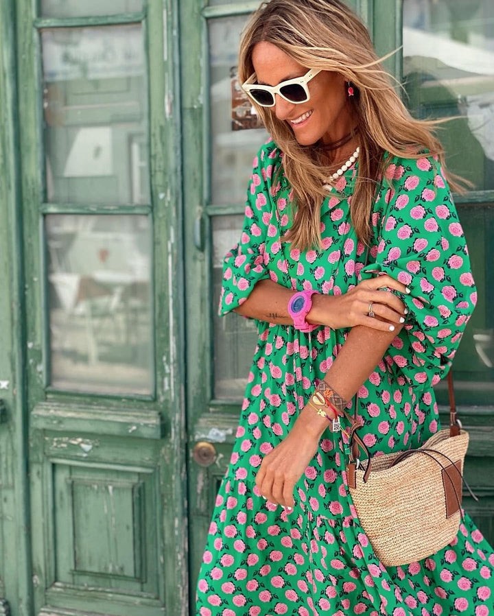 Model in a green and pink floral spring dress, showing the full-length silhouette and feminine design