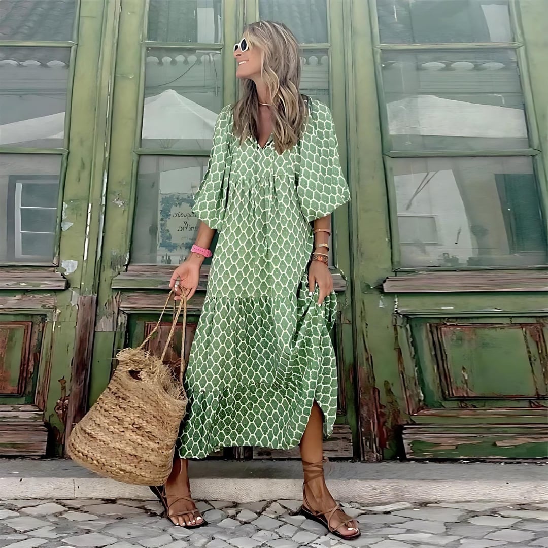 Styled flat lay of the green and white spring dress with accessories including sandals and a tote bag