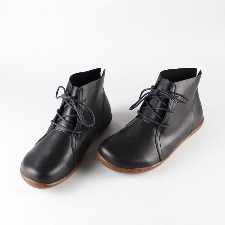 Hazel ankle boots in black displayed against a neutral background, highlighting smooth upper and supportive sole