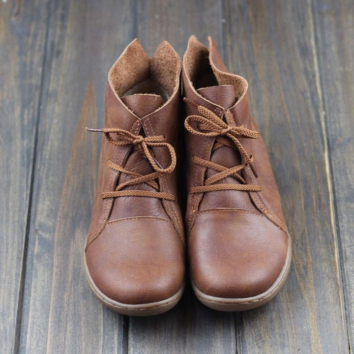 Side profile of Hazel ankle boots in brown showcasing leg-lengthening silhouette