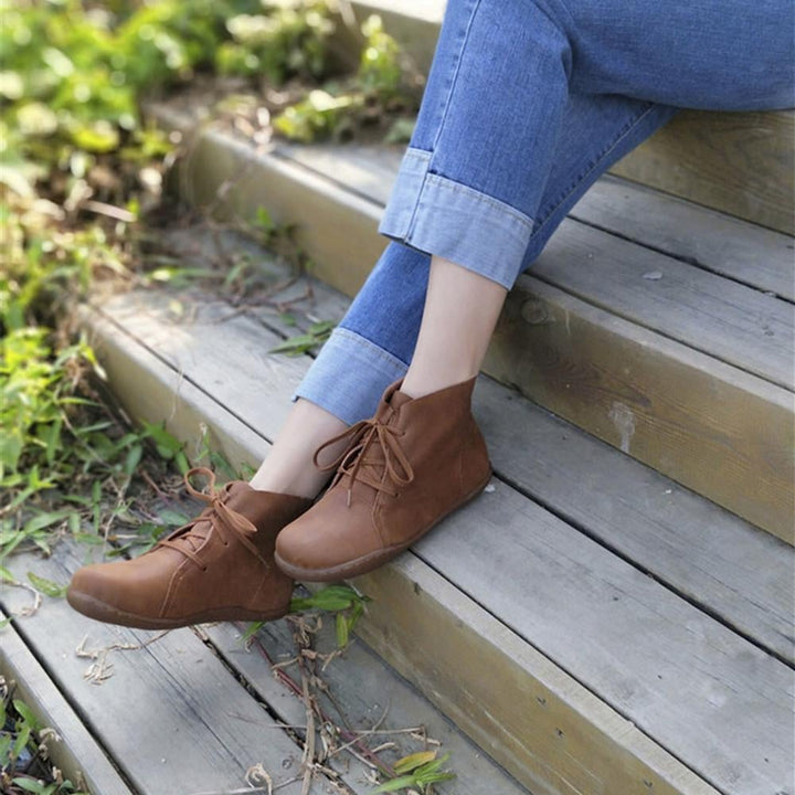 Overhead flat-lay of Hazel ankle boots in brown on a light surface