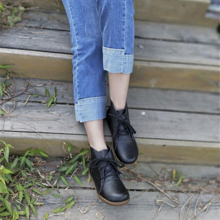 Lifestyle shot of Hazel ankle boots in brown styled with a fall outfit