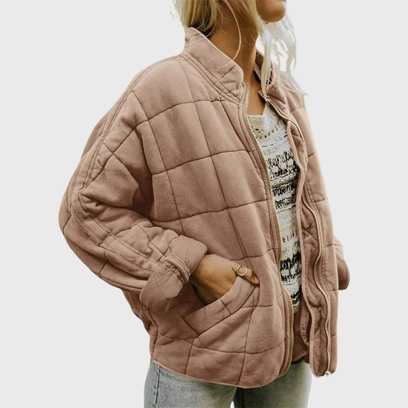 Side profile of the Hazel quilted jacket layered over a casual outfit, highlighting the sleeve length and overall fit