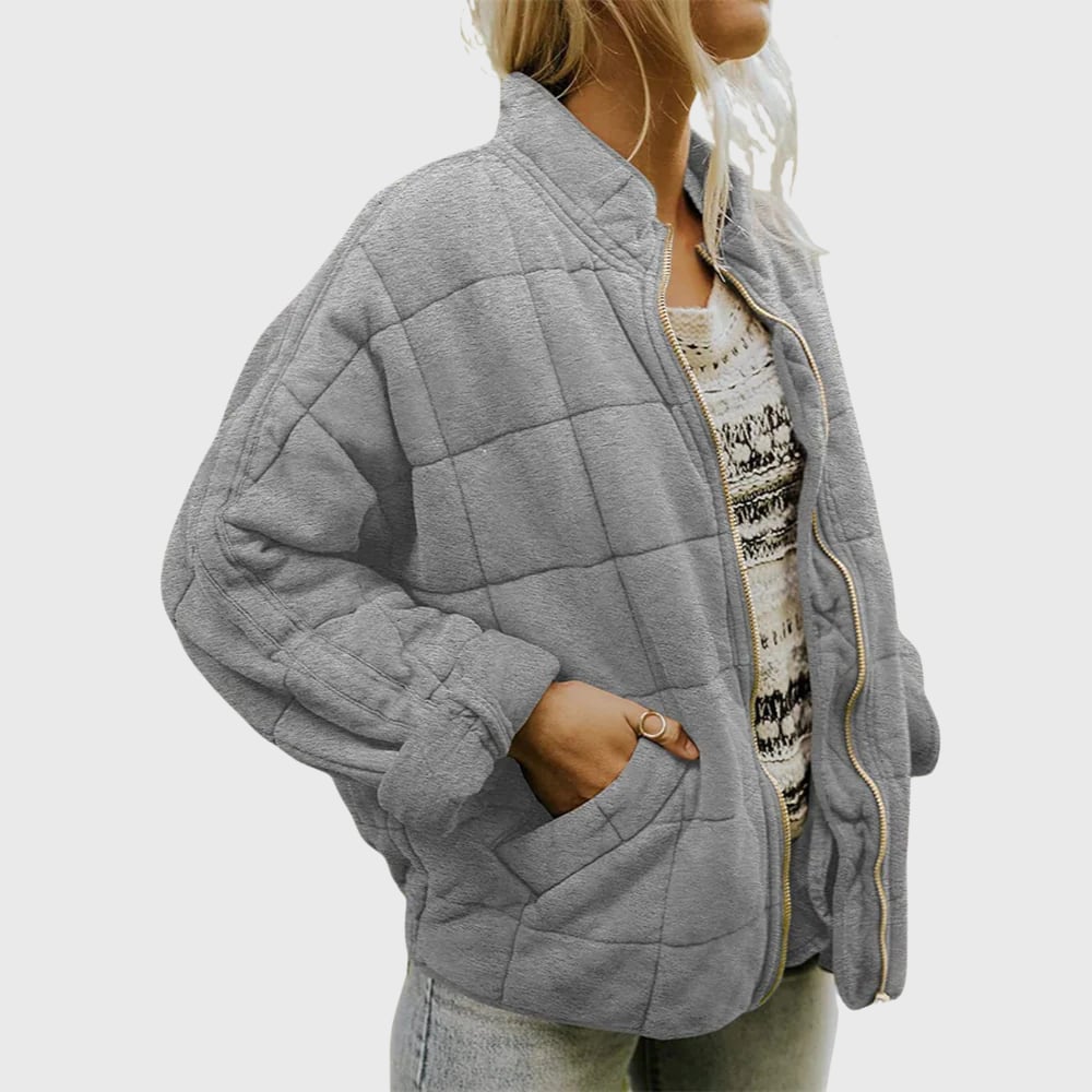Model wearing the Hazel elegant quilted jacket in black, paired with jeans for an effortlessly polished look