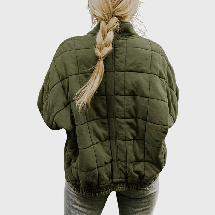 Flat lay of the Hazel quilted jacket in khaki displaying the full length, shoulder width, and quilted surface detail