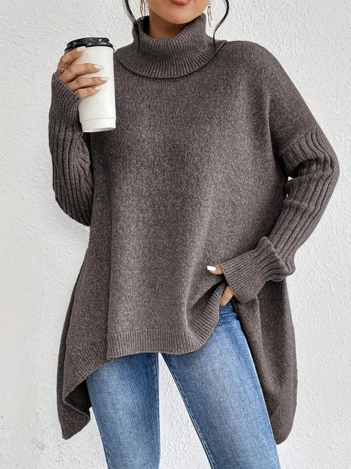 Model wearing the Hazel long sleeve sweater in dark green, layered over a casual outfit