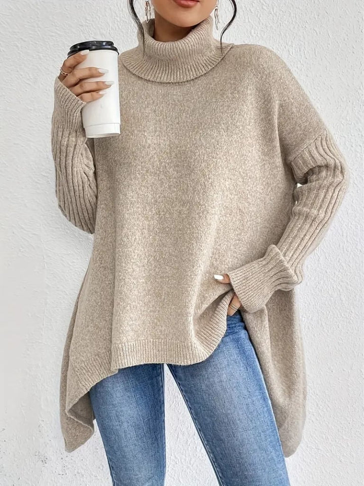 Model wearing the Hazel sweater in blue, paired with tailored trousers for a work-ready look