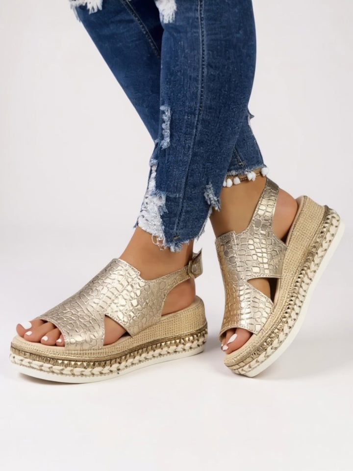Hazel metallic platform sandals in gold shown from the front on a white background