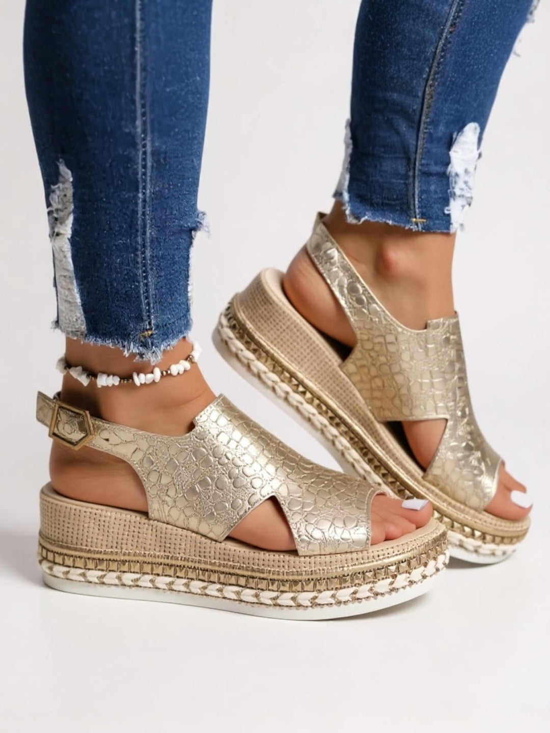 Close-up of the cushioned footbed on Hazel metallic platform sandals in gold