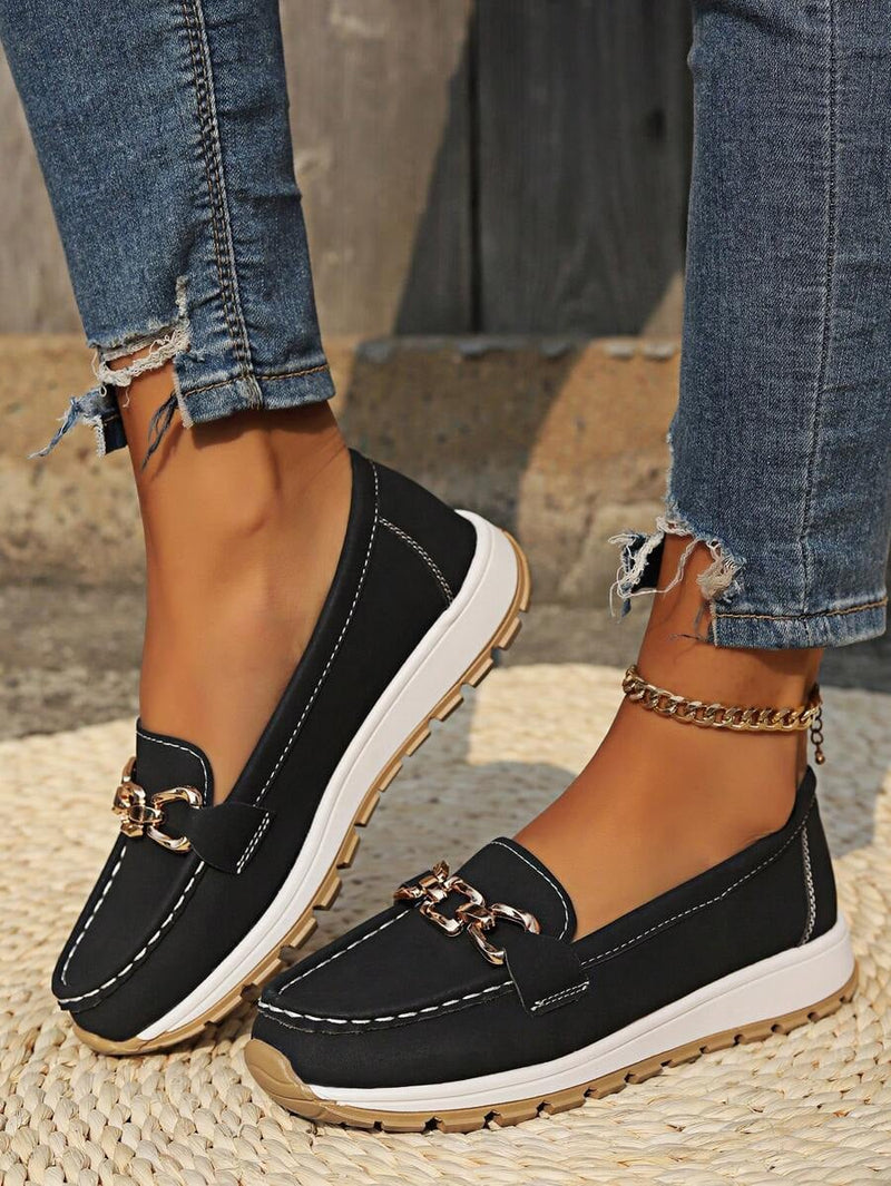Hazzie women's black chain bit slip-on loafers with gold hardware detail, front view