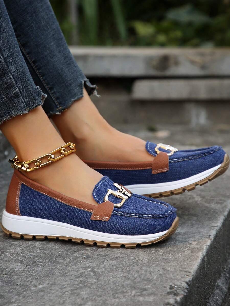 Hazzie navy loafers worn with distressed denim jeans, close-up styling shot