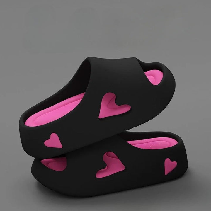 Soft heart flip flops in purple with heart-shaped cutout detail and cushioned platform sole