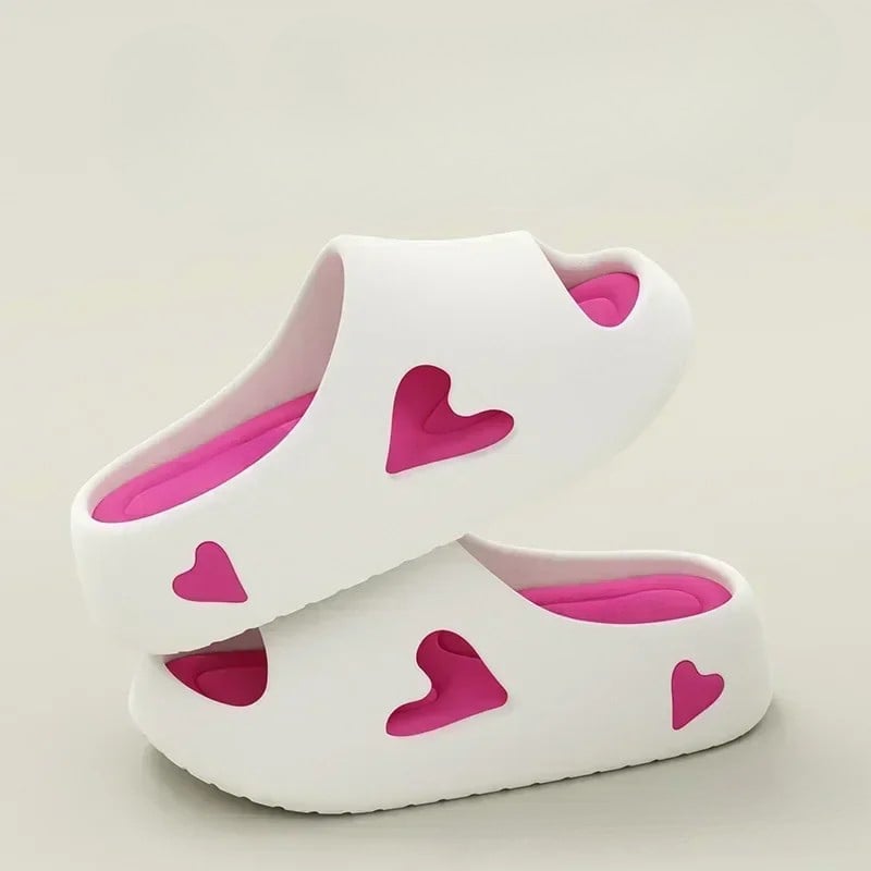 Heart flip flops flat lay on a bright summer background